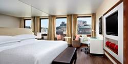 Bedroom at the Sheraton Grand Hotel & Spa with a view of Edinburgh Castle.