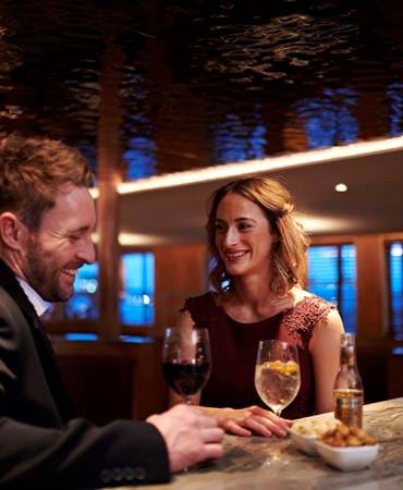 Two people enjoying cocktails at Fingal cocktail bar